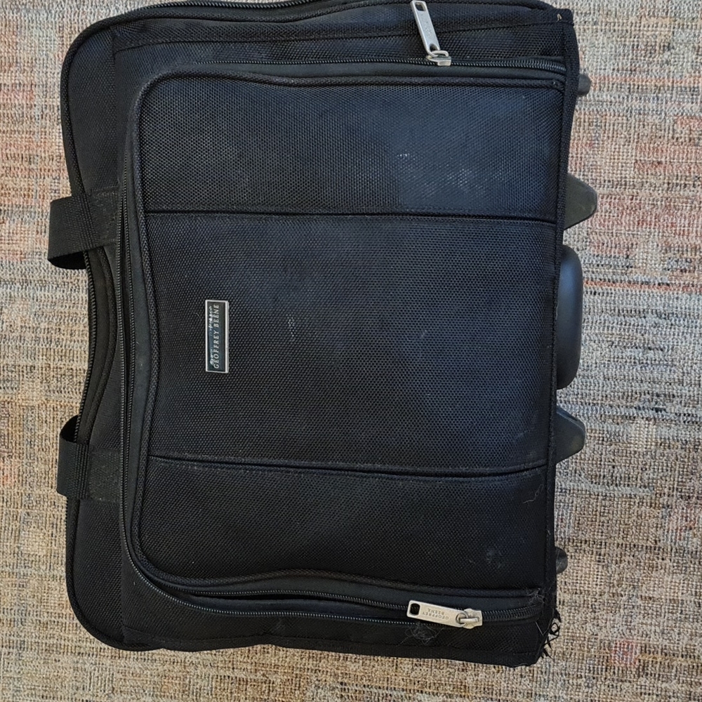 GEOFFREY BEENE rolling travel/carry-on bag. 16in by 12in. overall dimensions.